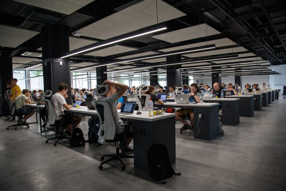 workers sitting at desks in a large office space