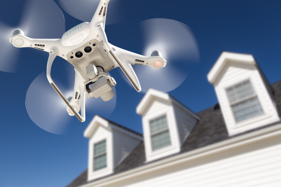 a drone with camera flying around a property exterior